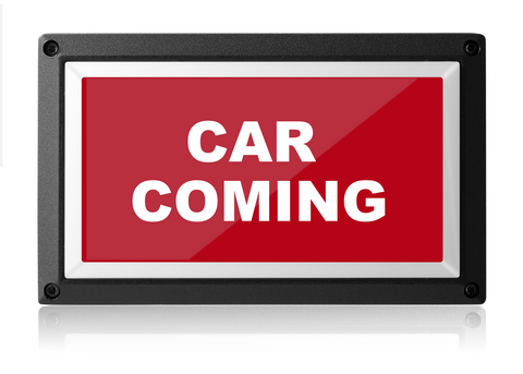 A Car Coming LED warning sign with a bold red background and white text reading "car coming" encased in a black rectangular frame, isolated on a white background.